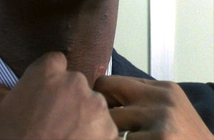 Vaughan does his best to hide a scar on his neck.