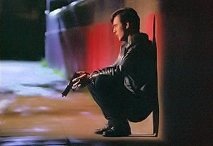 Mike leans against the wall.